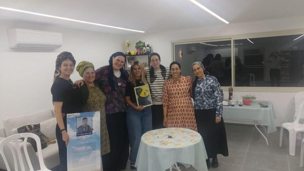 Tzila Siboni with some of the participants in the meeting held as part of the Ner BaSalon initiative
(Photo: Courtesy of the Gesher organization) צילה סיבוני עם כמה ממשתתפות המפגש שנערך מטעם מיזם "נר בסלון"