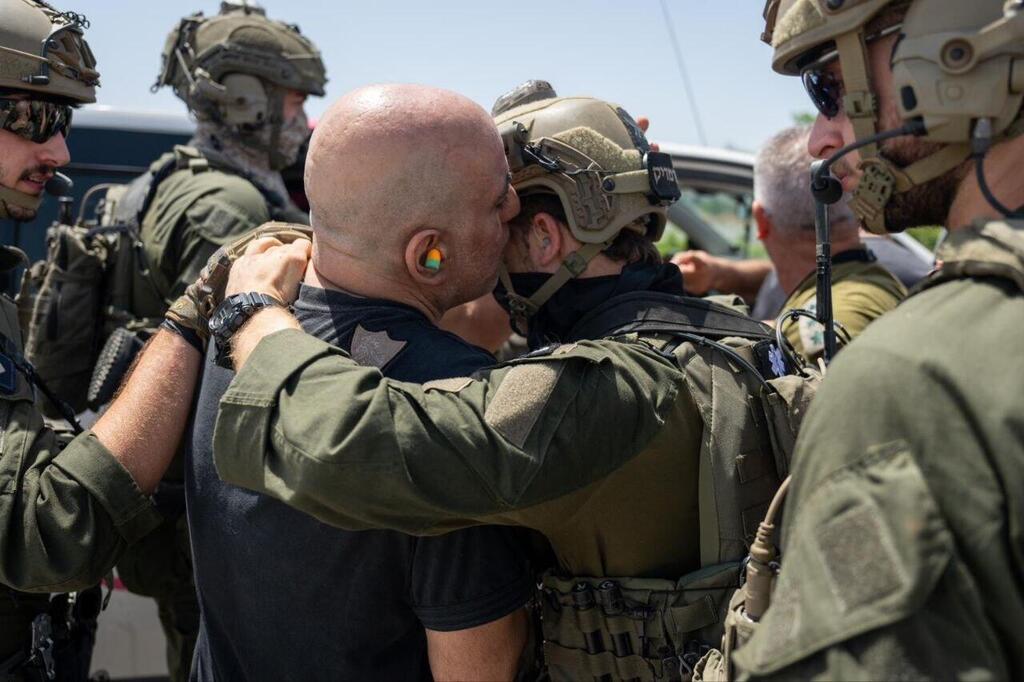 Ziv embraces his rescuers