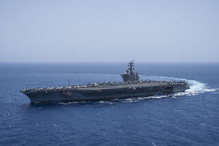 The USS aircraft carrier Dwight D. Eisenhower, also known as 'IKE', sails in the Red Sea; it has shot down Houthi fire and escorted vessels through the region.