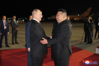 Russian President Vladimir Putin (L) received by North Korean leader Kim Jong Un in Pyongyang 