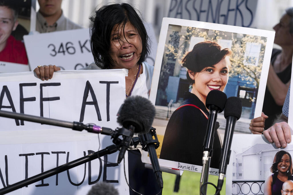 Clariss Moore, parent of Danielle, one of the crash victims of a Boeing 737 Max 8 in Ethiopia, holds her photograph while speaking at a news conference in 2024