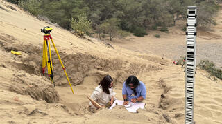 A team of archeologists work on what appear to be parts of a 4,000-year-old ceremonial temple buried in a sand dune of northern Peru, in Lambayeque, Peru
