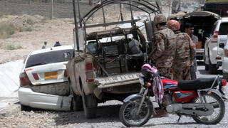 Pakistani security officials inspect the scene of a blast near a Frontier Corps vehicle on a roadside in Quetta, the provincial capital of the Balochistan province, Pakistan, on July 13, 2024. According to police, an explosive device planted by unknown suspected terrorists in the Akhtar Abad area near the Western Bypass in Quetta exploded and killed at least one person and injured two others.