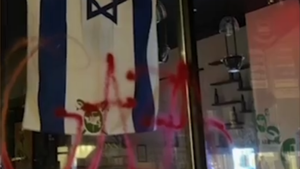 Pro-Palestinian slogans spray-painted on Caffè Aronne's windows 