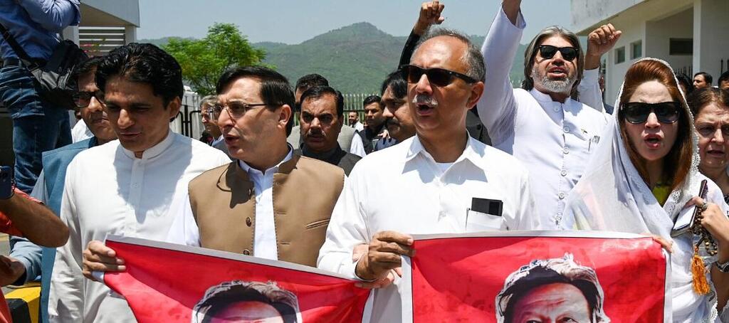 arliamentarians of the Pakistan Tehreek-e-Insaf (PTI) party, carry posters of jailed former prime minister Imran Khan 