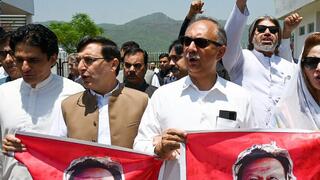 arliamentarians of the Pakistan Tehreek-e-Insaf (PTI) party, carry posters of jailed former prime minister Imran Khan 