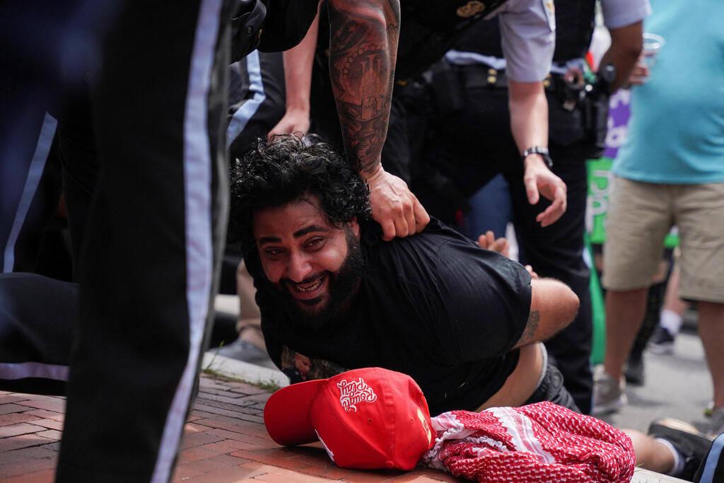 U.S. Park Police officers restrain a demonstrator on the ground at a pro-Palestinian protest