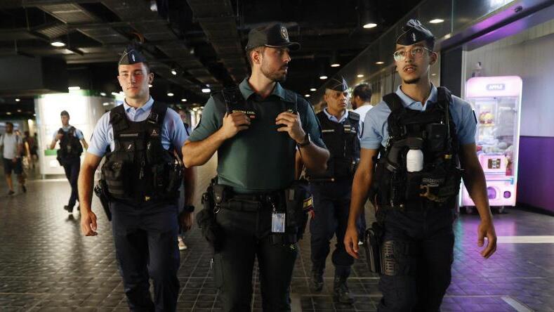 Police officers at a Paris train station 