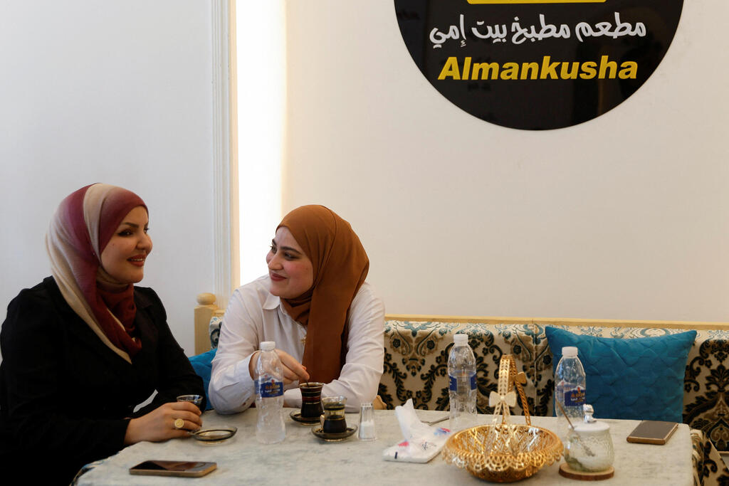 Women drink tea at a restaurant called "Beit Ummi" (Arabic for 'The House of My Mother') a decade after Islamic State militants entered the city, in a push to bring the neighborhood back to life, in the Old City of Mosul, Iraq