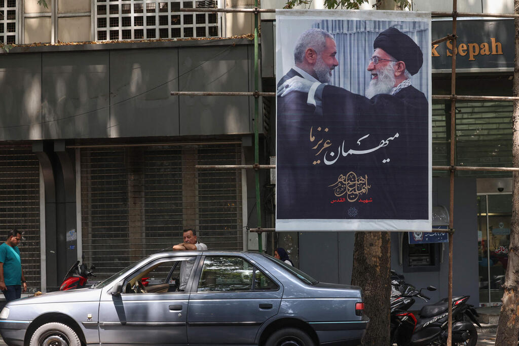 Tehran poster shows slaim Hamas leader Ismail Haniyeh with Ali Khamenei 