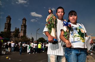 Two devotees with images at the San Hipolito Church in Mexico City 