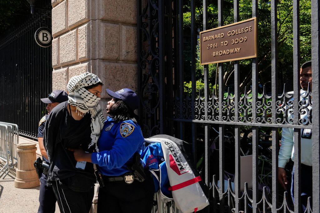 A pro-Palestinian protester is detained by NYPD officers outside of Barnard College on the first day of the new semester, in New York City,  September 3, 2024 