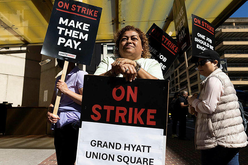 Yesenia Salas stands as hotel workers picket outside the Grand Hyatt hotel Monday