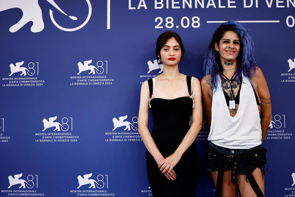 Nora Lifshitz and actor Ori Avinoam pose during a photocall for the movie "Al klavim veanashim" (Of Dogs and Men) at Venice Film Festival