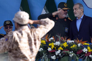 Iranian President Masoud Pezeshkian, right, and  commander of the Revolutionary Guard's ground force Gen. Mohammad Pakpour during a military parade in Tehran 