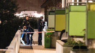 Danish police and forensic technicians examine site of explosion at a residential building next to the Israeli embassy in Copenhagen, Denmark on October 7