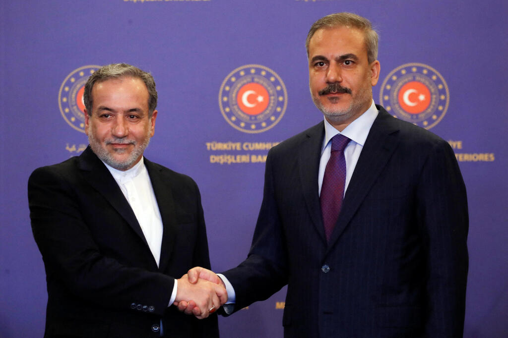 Turkish Foreign Minister Hakan Fidan shakes hands with his Iranian counterpart Abbas Araqchi  in Istanbul on Saturday 