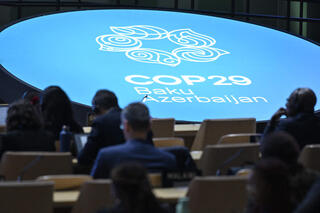 Participants listen to speeches during the United Nations Climate Change Conference (COP29) in Baku on November 13, 2024