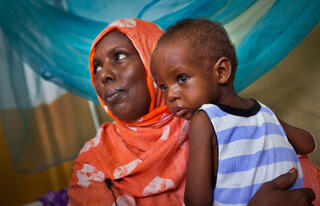 Somalia famine, diseases, Saka Farah, mother of 12 children, with her one-year-old son Abdi 