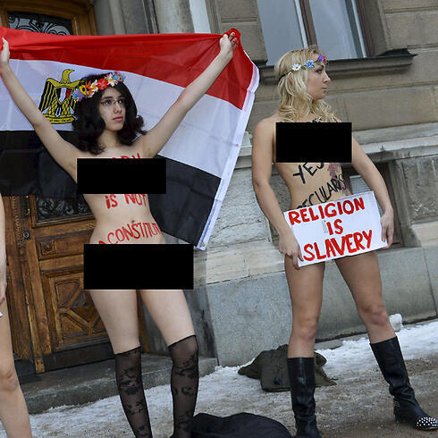 Elmahdy (left) protesting at Egyptian embassy in Sweden (Photo: AFP)