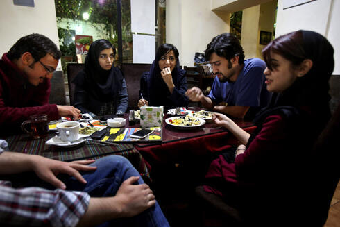 Young Iranian adults sit at a cafe in Tehran (Photo: AP)