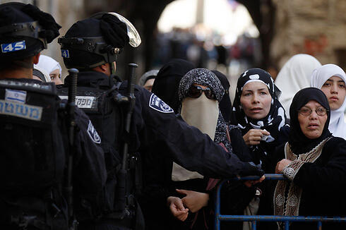 Palestinians at a barrier in East Jerusalem (Photo: Reuters)