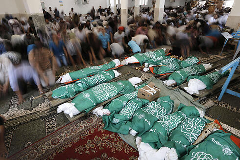 Bodies wrapped in Hamas flags (Photo: AFP)