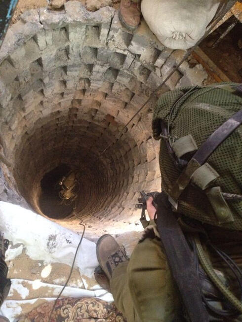 IDF soldier looks down shaft of Gaza terror tunnels (Photo: IDF)