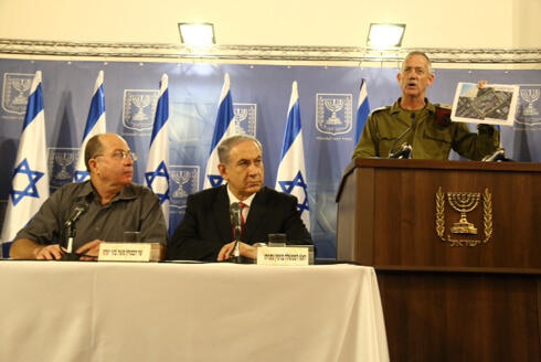 IDF Chief of Staff Gantz holding up a photo proving Gaza terrorists rocket hit Shifa hospital (Photo: Dana Kopel)