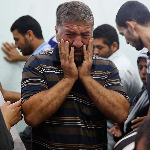 A Palestinian man mourns after an IDF strike on an UNRWA school in Gaza that killed 14 people. (Photo: Reuters)