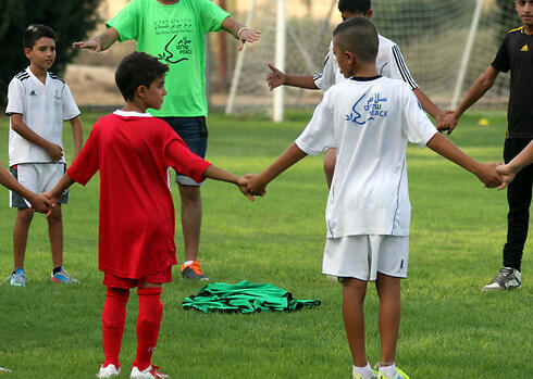 File Photo: Palestinian and Israeli children play soccer 