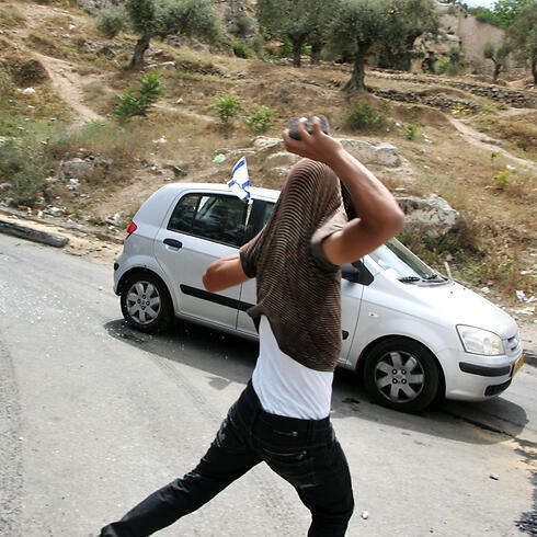 A Palestinian throwing stones in Silwan, East Jerusalem. (Photo: EPA) (צילום: EPA) A Palestinian throwing stones in Silwan, East Jerusalem. (Photo: EPA)