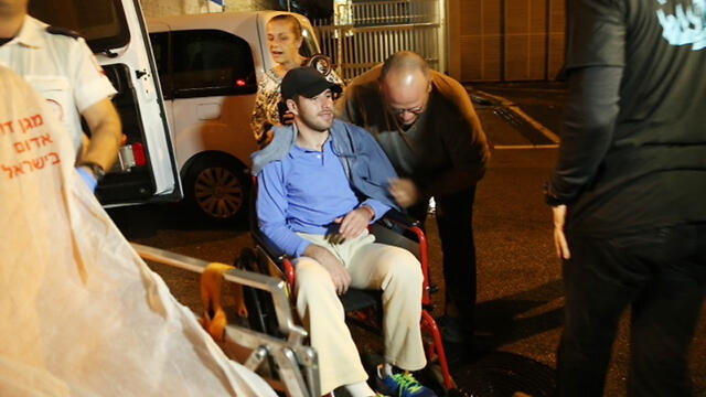 Wounded IDF soldier Ohad Ben-Yishai is wheeled into his 20th birthday party. (Photo: Motti Kimchi) (צילום: מוטי קמחי ) Wounded IDF soldier Ohad Ben-Yishai is wheeled into his 20th birthday party. (Photo: Motti Kimchi)