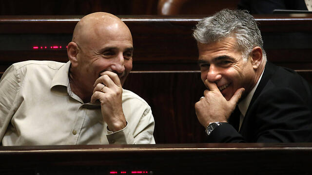 Yesh Atid faction chairman Ofer Shelah and Lapid (צילום: AFP) Yesh Atid faction chairman Ofer Shelah and Lapid