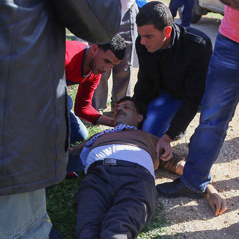 Abu Ein after he collapsed, in the West Bank (Photo: Reuters)