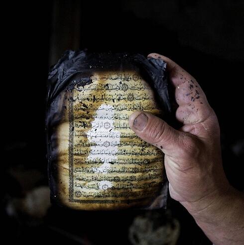 A koran that was burned during the fire in a mosque in the West Bank in November. (Photo: Associated Press)