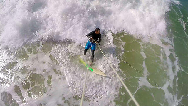 Surfer at Beit Yanai beach (Photo: Eli Hasson)