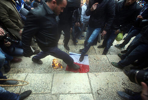 Palestinians stomp on French flag near Al-Aqsa mosque. (Photo: EPA)