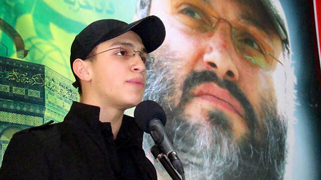 Mughniyeh with an image of his father