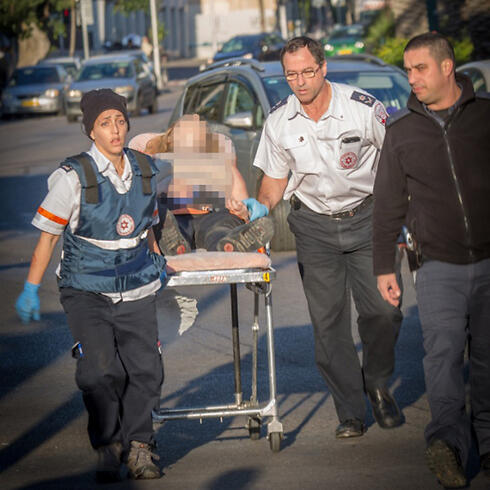 Rescue personnel rush a wounded man from the site of the attack. (Photo: Magen David Adom)