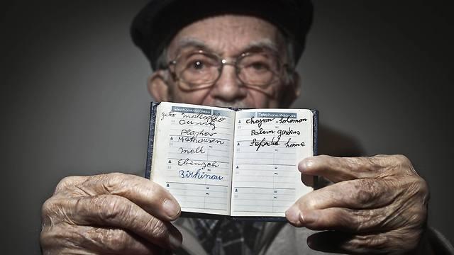 Hy Abrams and his leather book (Photo: Reuters)
