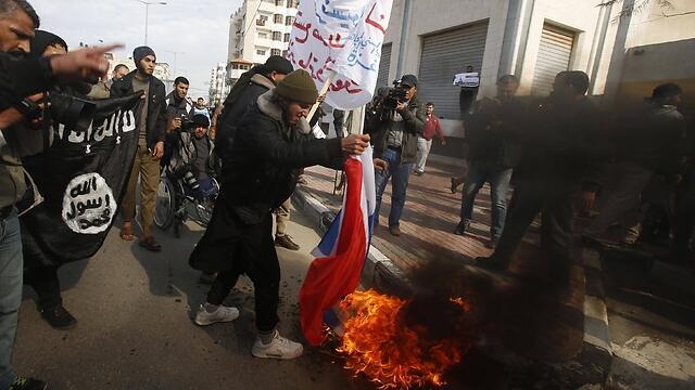 French flag burned and Islamic State flag wave during Gaza rally.(Photo: Reuters) (Photo: Reuters) French flag burned and Islamic State flag wave during Gaza rally.(Photo: Reuters)