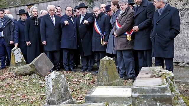 Hollande, center, with at his right, Israeli ambassador to France Yossi Gal, points to desecrated tombstones during a visit at Sarre-Union Jewish cemetery, eastern France (Photo: Associated Press) (Associated Press) Hollande, center, with at his right, Israeli ambassador to France Yossi Gal, points to desecrated tombstones during a visit at Sarre-Union Jewish cemetery, eastern France (Photo: Associated Press)