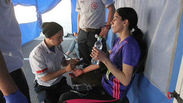 Runner treated at first-aid tent (Photo: Ido Erez)