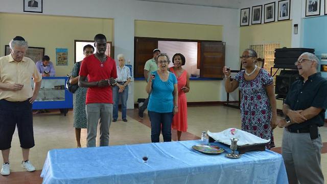 Handful of congregants hold glasses of kosher wine and sing in Jamaica's last synagogue, in Kingston (Photo: AP) (AP) Handful of congregants hold glasses of kosher wine and sing in Jamaica's last synagogue, in Kingston (Photo: AP)