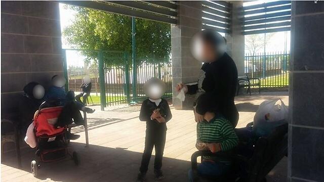 Visitors to Afula park eating their buns outside after being refused entry.nullnull Visitors to Afula park eating their buns outside after being refused entry.