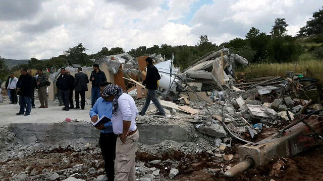 Residents of Kafr Kanna stand in the rubble of a demolished home (Photo: Hassan Shaalan)