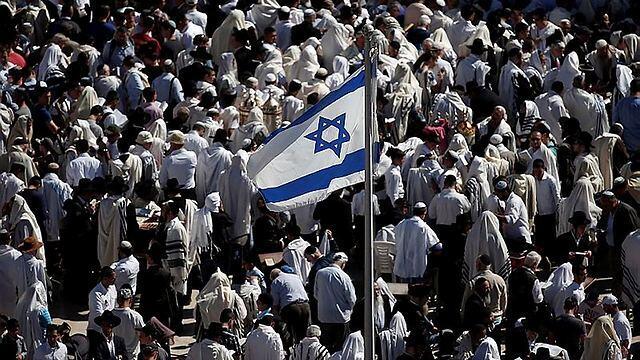 The Israeli flag flutters nearby (Photo: AFP)