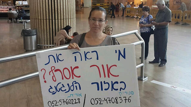 Orit Asraf, mother of Or, at the airport with a sign asking if anyone had seen her son nullnull Orit Asraf, mother of Or, at the airport with a sign asking if anyone had seen her son