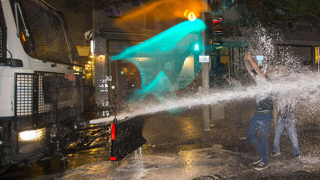 Police use water cannon on protesters in Rabin Square (Photo: AFP) 